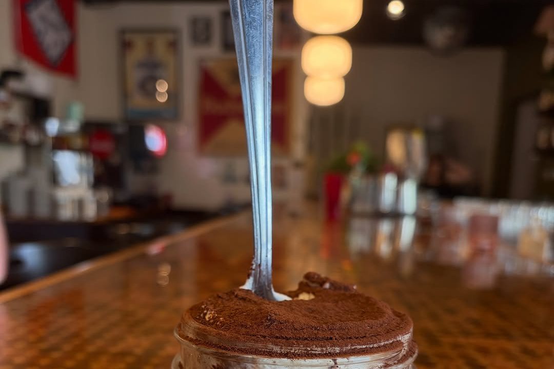 A jar of tiramisu on the wooden bar at Problem Child in Little Rock