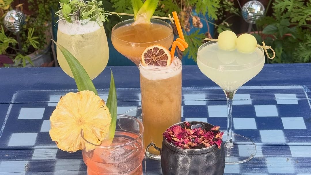 Signature cocktails lined up on a blue gingham table