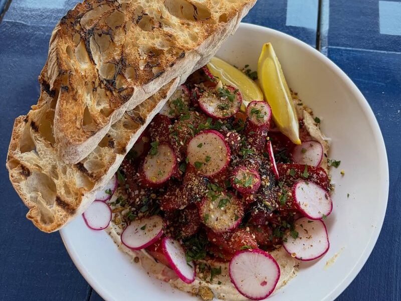 Pomegranate-glazed carrots with radish, tahini, dukkah and grilled bread